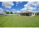 A sprawling backyard featuring a screened lanai, perfect for outdoor entertainment at 23141 Corvin Ave, Port Charlotte, FL 33954