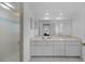 Bright bathroom features a glass shower, large vanity, and a spacious mirror at 23141 Corvin Ave, Port Charlotte, FL 33954