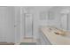 Bathroom features a shower with glass door, vanity with sink and tiled floors at 23141 Corvin Ave, Port Charlotte, FL 33954
