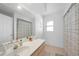 This bathroom features a large mirror, neutral color palette, and plenty of counter space at 23141 Corvin Ave, Port Charlotte, FL 33954