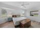 Bedroom featuring a wooden bed frame, ample natural light, and wood-look floors at 23141 Corvin Ave, Port Charlotte, FL 33954