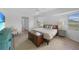 Bedroom features a wooden bed frame, ample natural light and wood-look floors at 23141 Corvin Ave, Port Charlotte, FL 33954