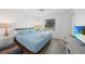 This bedroom features a comfortable queen bed, calming color palette, and natural light at 23141 Corvin Ave, Port Charlotte, FL 33954
