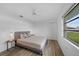 This bedroom is bright and airy with natural light and a ceiling fan at 23141 Corvin Ave, Port Charlotte, FL 33954