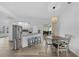 The dining area is open to the kitchen with stainless steel appliances and wood-look floors at 23141 Corvin Ave, Port Charlotte, FL 33954