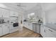Bright kitchen features modern appliances, wood-look floors, ample counter space, and lots of natural light at 23141 Corvin Ave, Port Charlotte, FL 33954