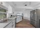 The kitchen features stainless steel appliances, white cabinets, and wood-look flooring at 23141 Corvin Ave, Port Charlotte, FL 33954