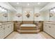 Bright bathroom with tiled floor, neutral paint, and a bathtub in the center at 2329 Como St, Port Charlotte, FL 33948