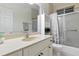 Bright bathroom featuring a shower/tub combo and vanity with an oversized mirror at 2329 Como St, Port Charlotte, FL 33948