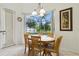 Bright dining area features a wood table and chairs, with a view of the screened pool area at 2329 Como St, Port Charlotte, FL 33948