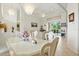 Open-concept dining area featuring tile floors, elegant light fixtures, and a bright window at 2329 Como St, Port Charlotte, FL 33948