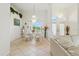 Inviting dining room with elegant lighting fixture, tile floors, and large windows at 2329 Como St, Port Charlotte, FL 33948