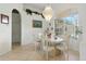 Dining area featuring bright light fixture, tile floors, and a large window at 2329 Como St, Port Charlotte, FL 33948