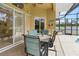 Relaxing covered lanai with ceiling fan offering comfortable outdoor dining and pool access at 2329 Como St, Port Charlotte, FL 33948