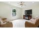 Cozy living room with comfortable seating, tile floors, a ceiling fan, and a view to the backyard at 2329 Como St, Port Charlotte, FL 33948
