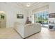 Bright living room with tile floors, high ceiling and large windows leading to the outdoor patio area at 2329 Como St, Port Charlotte, FL 33948