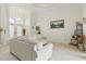 Bright living space with tile floors, elegant lighting fixtures, and high ceilings with large windows at 2329 Como St, Port Charlotte, FL 33948