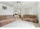 Spacious living room has comfortable couches, ceramic tile floors, and abundant natural light at 2329 Como St, Port Charlotte, FL 33948