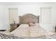 The main bedroom features a decorative headboard with neutral decor and bright windows at 2329 Como St, Port Charlotte, FL 33948