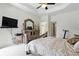 Bright main bedroom with tray ceilings, neutral paint, and decorative furniture at 2329 Como St, Port Charlotte, FL 33948