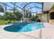 Inviting pool area, complete with a screened enclosure for year-round enjoyment and bug-free relaxation at 2329 Como St, Port Charlotte, FL 33948