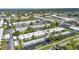Beautiful aerial view of a condo complex with parking, a swimming pool and surrounding trees and landscaping at 2437 Harbor Blvd # 114, Port Charlotte, FL 33952