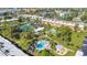 Aerial view showcases the community pool, clubhouse, and tennis courts at 2437 Harbor Blvd # 114, Port Charlotte, FL 33952