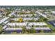 An aerial view of the complex showing multiple buildings, lush landscaping, and nearby parking areas at 2437 Harbor Blvd # 114, Port Charlotte, FL 33952