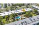 An aerial of the complex, displaying a shared community pool, lush landscaping and parking at 2437 Harbor Blvd # 114, Port Charlotte, FL 33952