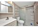 Bright bathroom with a shower, a modern sink, a vanity and a toilet at 2437 Harbor Blvd # 114, Port Charlotte, FL 33952