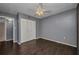 Bedroom with hardwood floors, closet, neutral paint and a ceiling fan at 2437 Harbor Blvd # 114, Port Charlotte, FL 33952