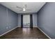 Cozy bedroom featuring a ceiling fan, a large window, and dark wood flooring at 2437 Harbor Blvd # 114, Port Charlotte, FL 33952