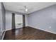 Bedroom with hardwood floors, gray walls, and a window with curtains at 2437 Harbor Blvd # 114, Port Charlotte, FL 33952