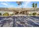 Building entrance shows lush landscaping, and a covered entrance for convenient access at 2437 Harbor Blvd # 114, Port Charlotte, FL 33952