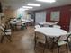 Community room with round tables, chairs, and tile flooring at 2437 Harbor Blvd # 114, Port Charlotte, FL 33952