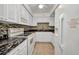 Updated kitchen with white appliances and tile backsplash at 2437 Harbor Blvd # 114, Port Charlotte, FL 33952