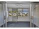 Enclosed lanai with tile flooring, many windows and a ceiling fan at 2437 Harbor Blvd # 114, Port Charlotte, FL 33952