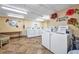 Community laundry room with multiple machines and a decorative theme at 2437 Harbor Blvd # 114, Port Charlotte, FL 33952