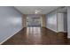 Open living room featuring wood floors, ceiling fan, and sliding glass doors to the patio at 2437 Harbor Blvd # 114, Port Charlotte, FL 33952