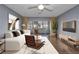 Inviting living room features modern furnishings, wood floors, and sliding glass doors to a sunroom at 2437 Harbor Blvd # 114, Port Charlotte, FL 33952