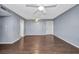 Empty living room with ceiling fans, wood floors, and neutral walls at 2437 Harbor Blvd # 114, Port Charlotte, FL 33952