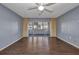 Cozy living room featuring a ceiling fan and sliding glass doors to an enclosed lanai at 2437 Harbor Blvd # 114, Port Charlotte, FL 33952