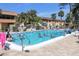 Outdoor pool area with residents enjoying the clear, blue water in the Florida sunshine at 2437 Harbor Blvd # 114, Port Charlotte, FL 33952