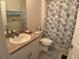 Cozy bathroom featuring a white vanity, a framed mirror, and a shower with a decorative curtain at 25228 E Lenox Cir, Punta Gorda, FL 33950