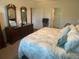 Bedroom featuring traditional wooden furniture and a tropical duvet cover at 25228 E Lenox Cir, Punta Gorda, FL 33950