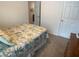 Carpeted bedroom featuring floral bedding, a view of the closet, hallway and dresser at 25228 E Lenox Cir, Punta Gorda, FL 33950