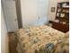Bedroom featuring carpet, floral bedding, a view of the closet and dresser with bookshelf at 25228 E Lenox Cir, Punta Gorda, FL 33950