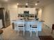 Kitchen featuring stainless steel appliances, white cabinets, and a center island with bar seating at 25228 E Lenox Cir, Punta Gorda, FL 33950