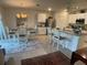 Bright kitchen and dining area features white cabinetry, stainless steel appliances, and a large island at 25228 E Lenox Cir, Punta Gorda, FL 33950