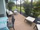 Comfortable screened lanai featuring cozy seating amidst lush landscaping, ideal for relaxation at 25228 E Lenox Cir, Punta Gorda, FL 33950